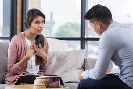 A man and a woman in a discussion in an office