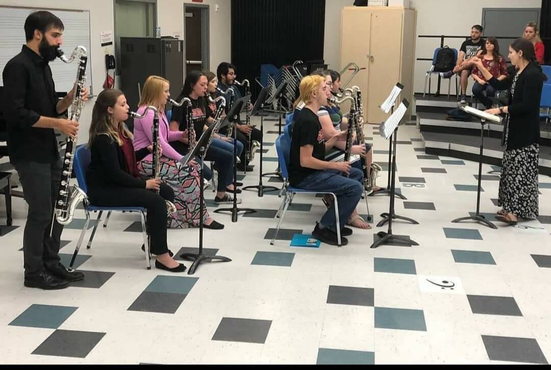 Bass Clarinet Choir students playing while other students look on.