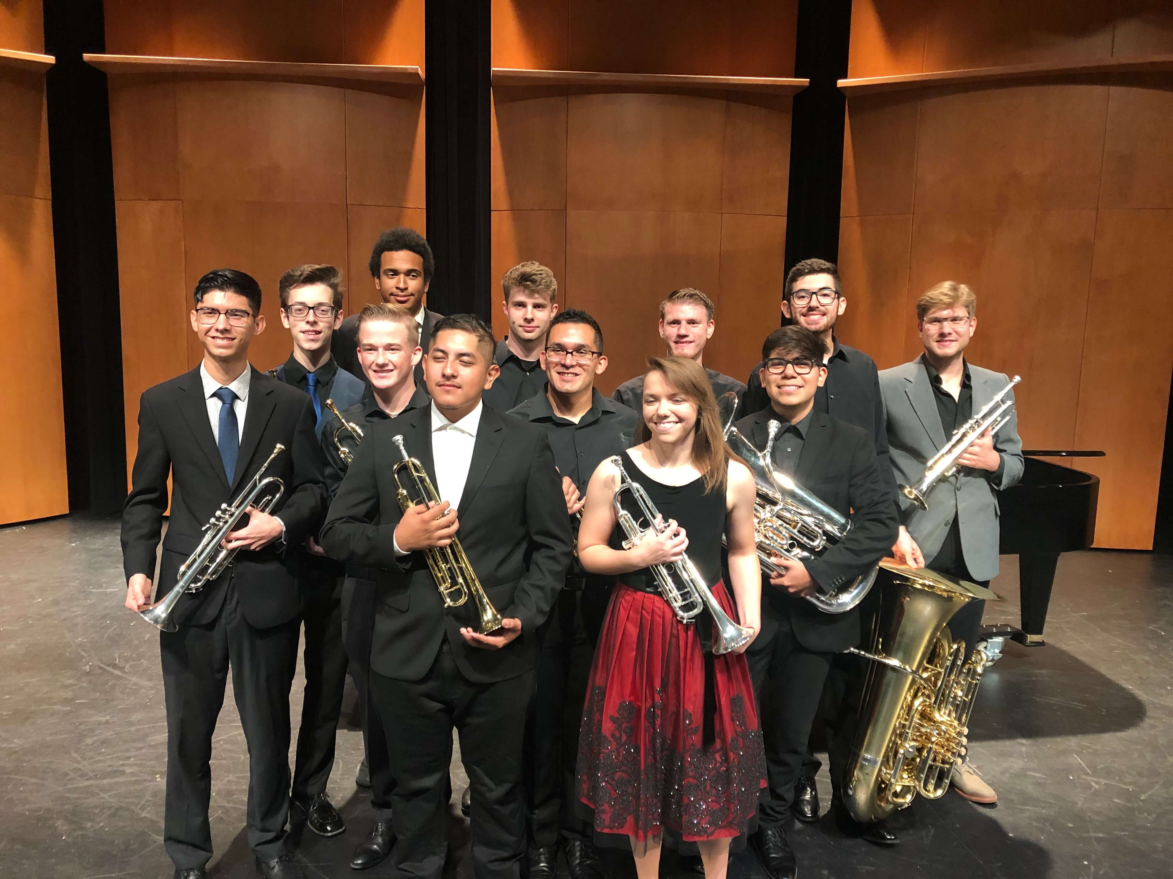 Brass ensemble students standing on stage after a performance