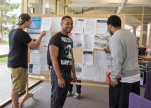 Students looking at a job posting board.