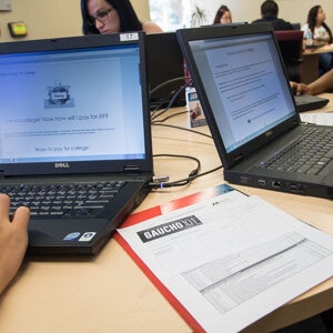 Laptops on workspace showing Gaucho New Student Advising work