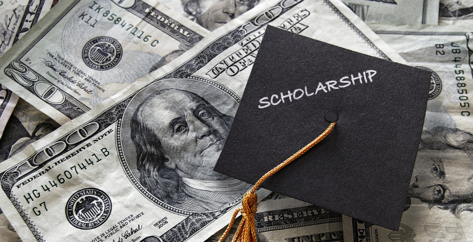 Graduation cap sitting on $100 bills
