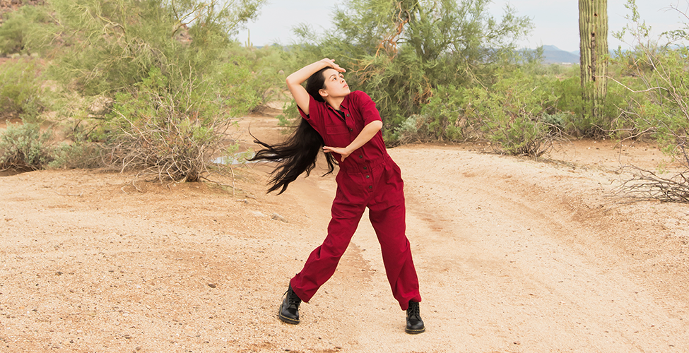 Dancer in red against a desert background