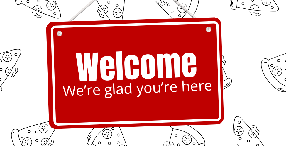 Red hanging sign with the words, "Welcome, we're glad you're here," in white.