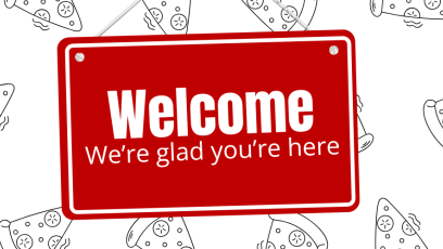 Red hanging sign with the words, "Welcome, we're glad you're here," in white.