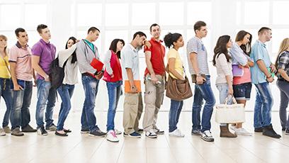 College students bored waiting in line.