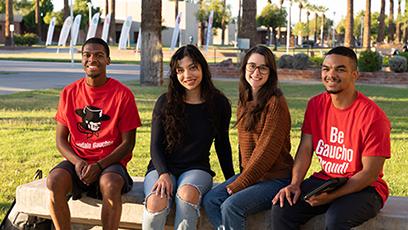 GCC students sitting outside the Business building.