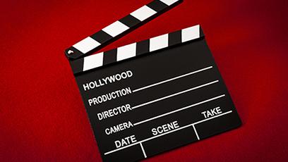 Movie clapperboard on a red background