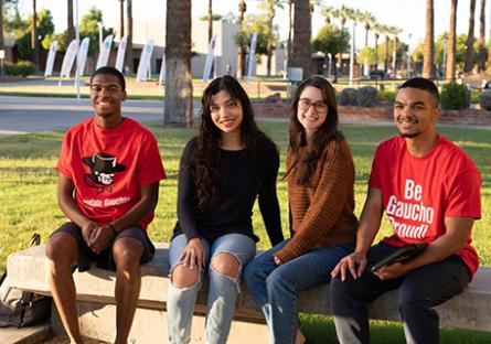 GCC students sitting outside the Business building.