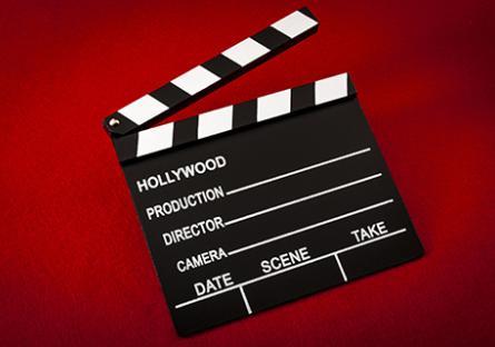 Movie clapperboard on a red background