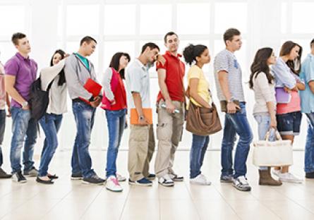 College students bored waiting in line.