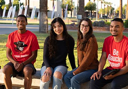 GCC students sitting outside the Business building.