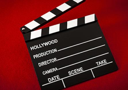 Movie clapperboard on a red background