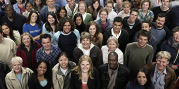 Large diverse crowd of smiling people.
