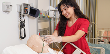 GCC nursing student learning to care for a patient.