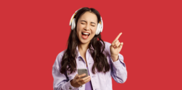 Female student wearing headphones singing along to music.