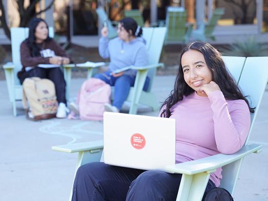 Female student studying outside the LS Building.