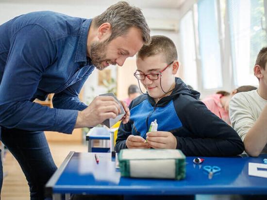 Teacher working with young students in a classroom