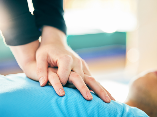 Hands on chest of person for CPR