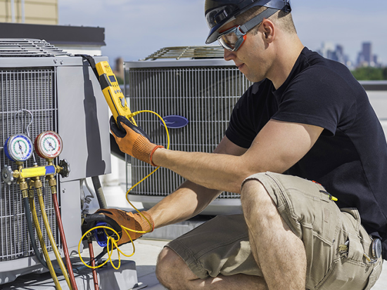 HVAC Technician working on an air conditioning unit.