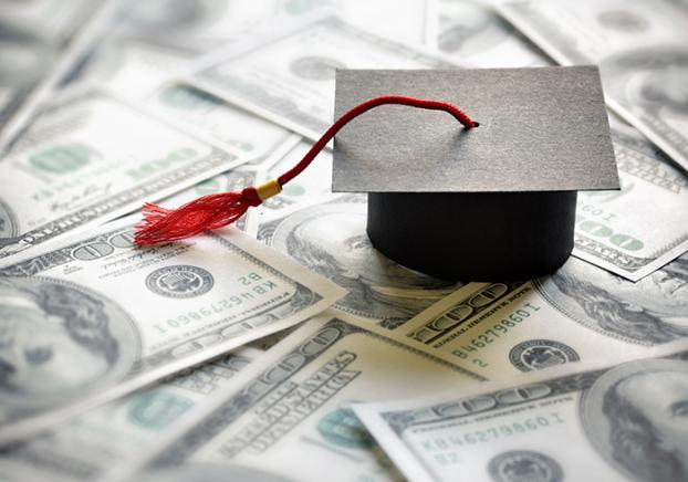 Mini graduation cap set on $100 bills.