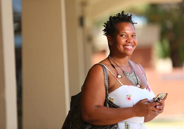 Student smiling walking out of a study session