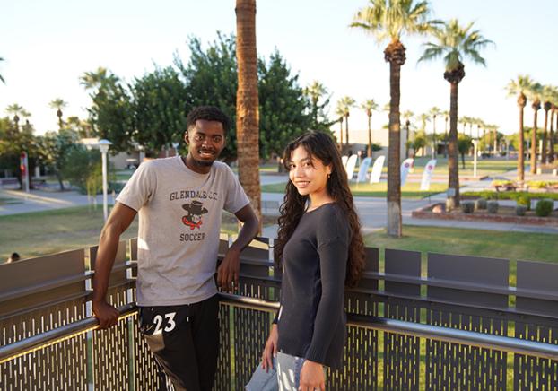 GCC students standing on a landing looking over the Central Mall.