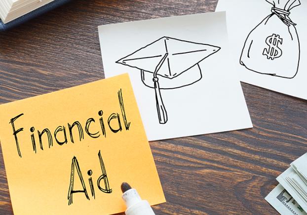 Yellow sticky note with the words Financial Aid in black.