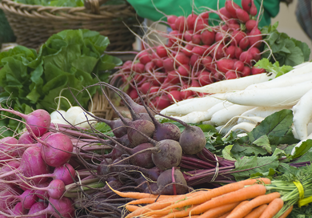 Colorful foods displayed at a farmers market.