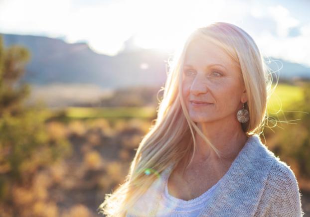 A woman enjoying the fresh air in a beautiful desert landscape.