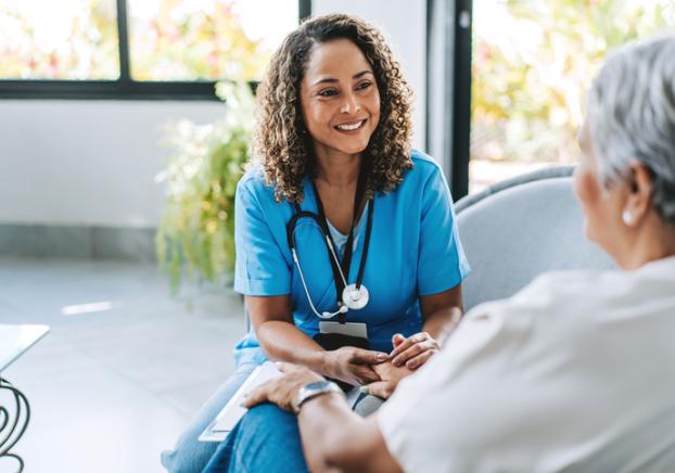 A picture of a healthcare professional having a conversation with a client or patient.