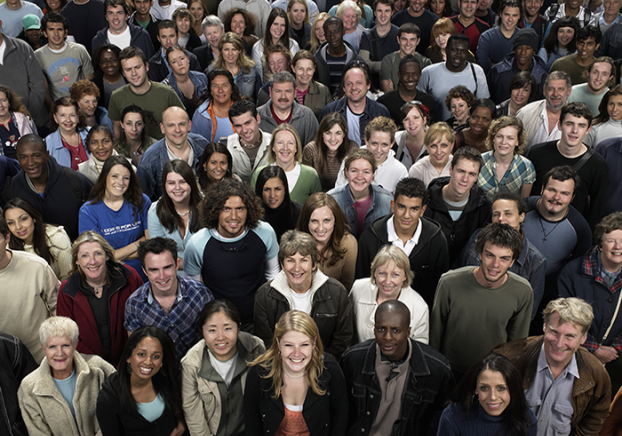 Large crowd of smiling diverse people.