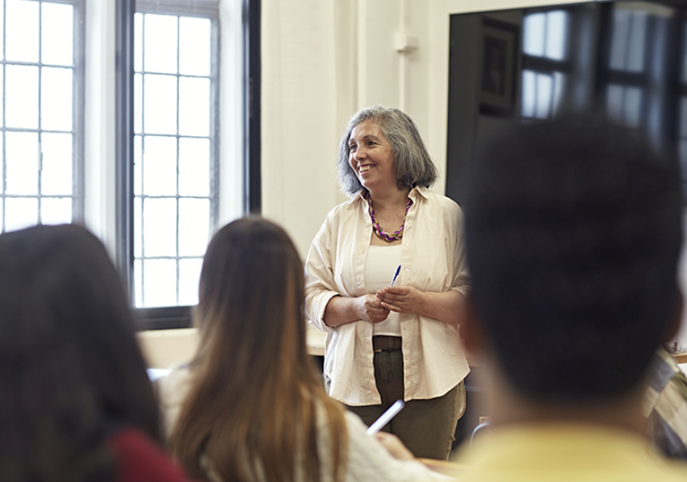 Smiling woman teaching a community ed class.