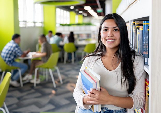 Smiling student spending time in a library