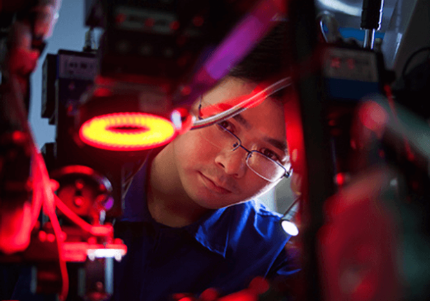 Engineering student working with a robot