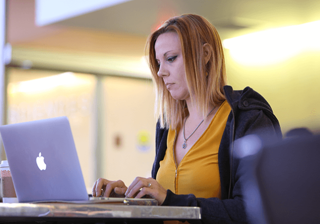 Student typing on a laptop
