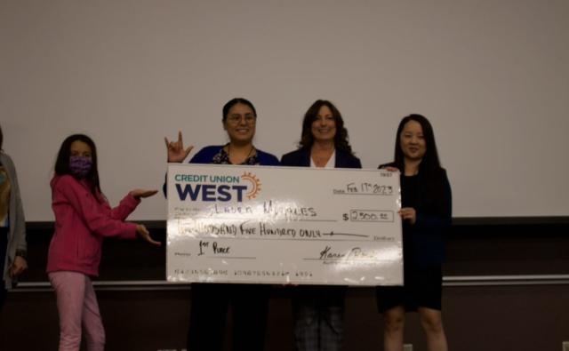 Laura Morales receiving her $2,500 award for 1st place